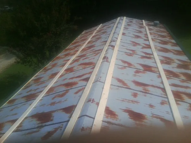 Rusted metal roof panels with new wood purlins before replacement — Storm Damage Roof Repair in Sanderson by Roofing Brothers